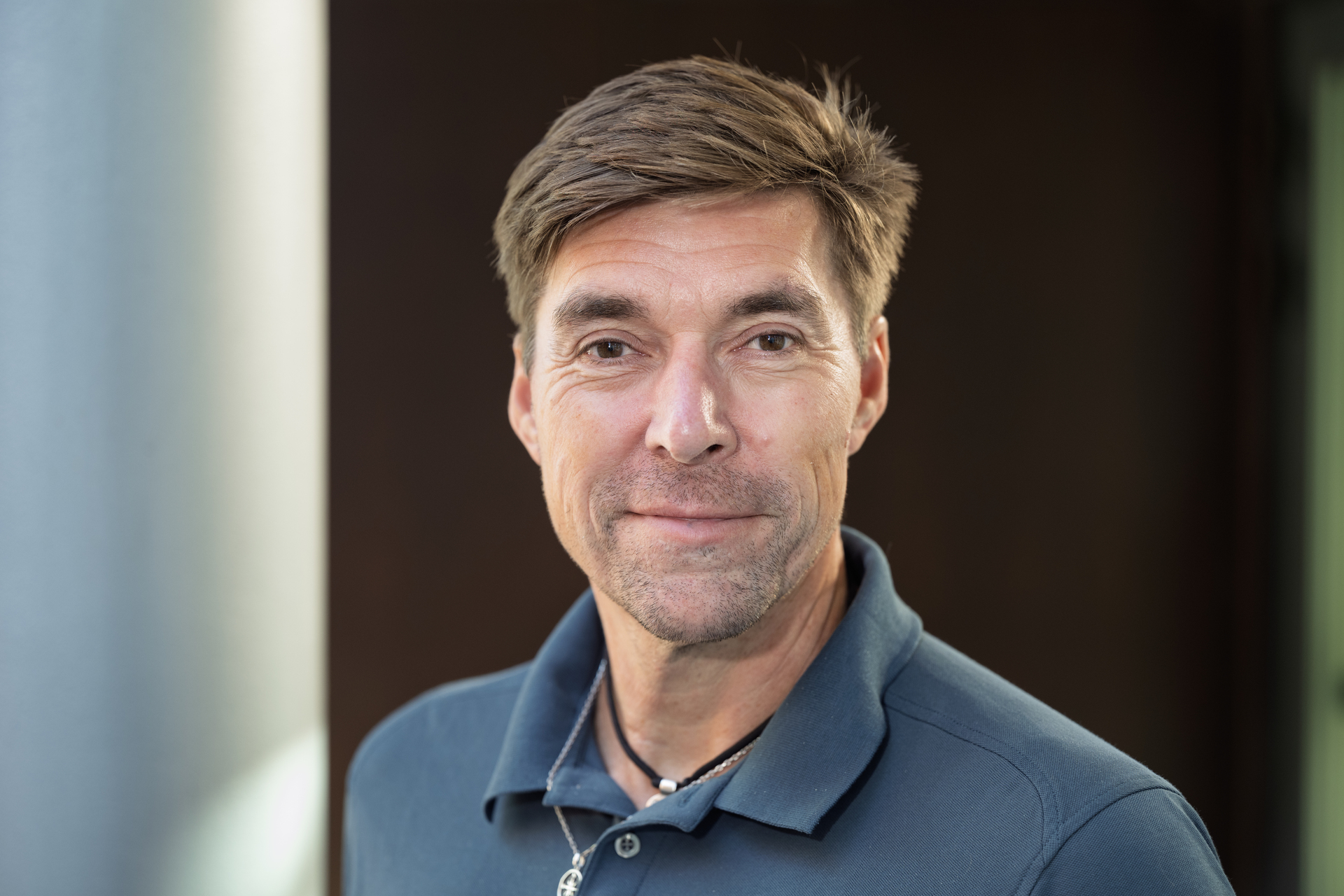 Man with brown hair and pique shirt. Close-up from the shoulders up
