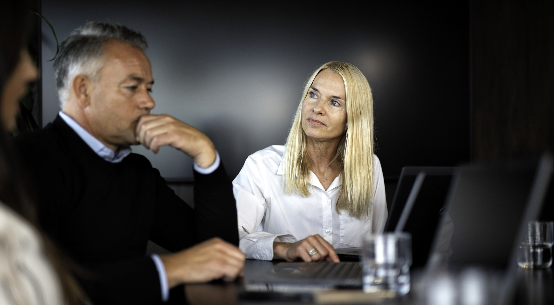 Uncertain male engineer in a discussion meeting with a female employer before a possible dismissal in a downsizing.