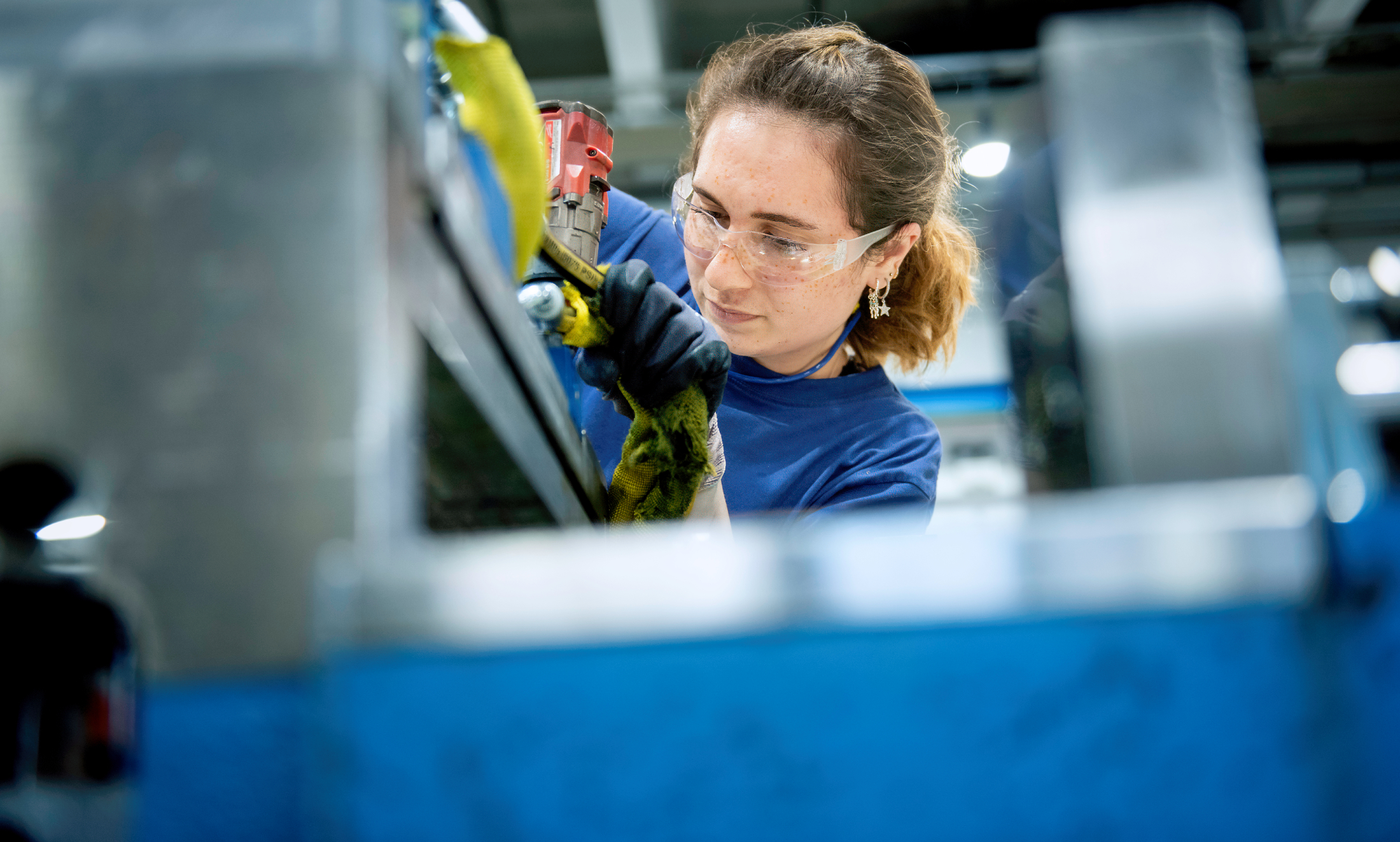 A young engineer at work. She examines equipment and machines in a company.